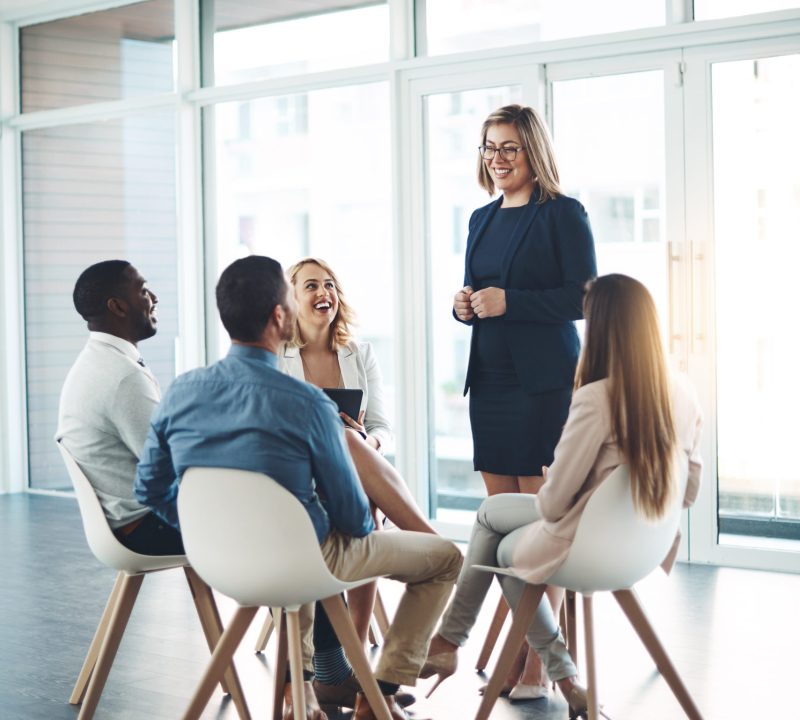 Workplace Communication trainer speaking to team of business employees